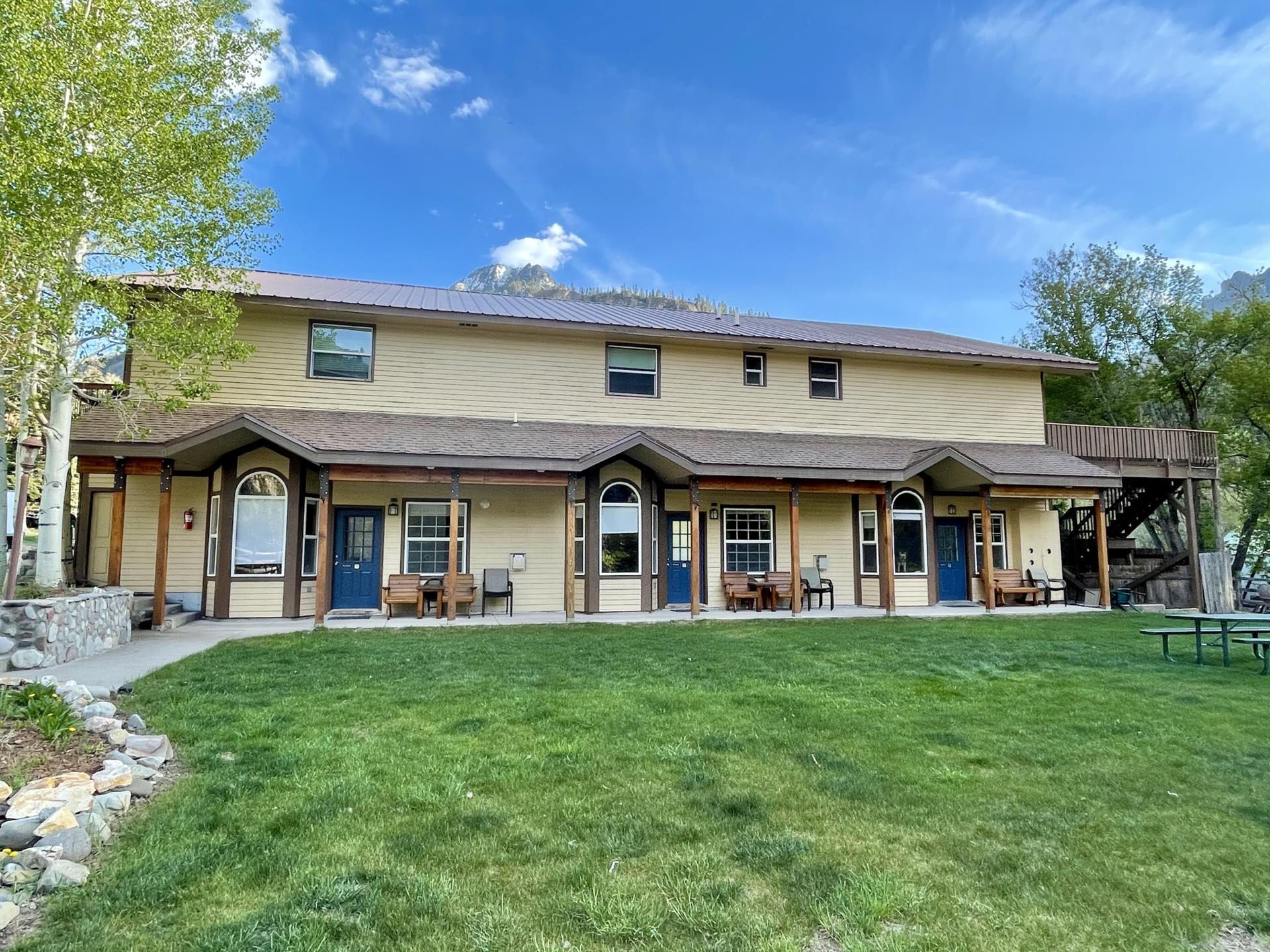 Ground-floor condos with a covered porch opening onto the lawn