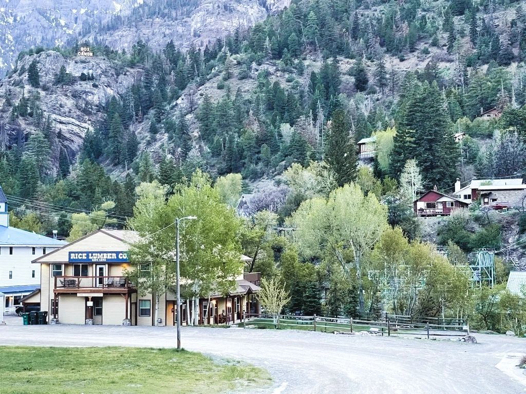 Full kitchen with black appliances and wood cabinets — Lumberyard Condos Ouray
