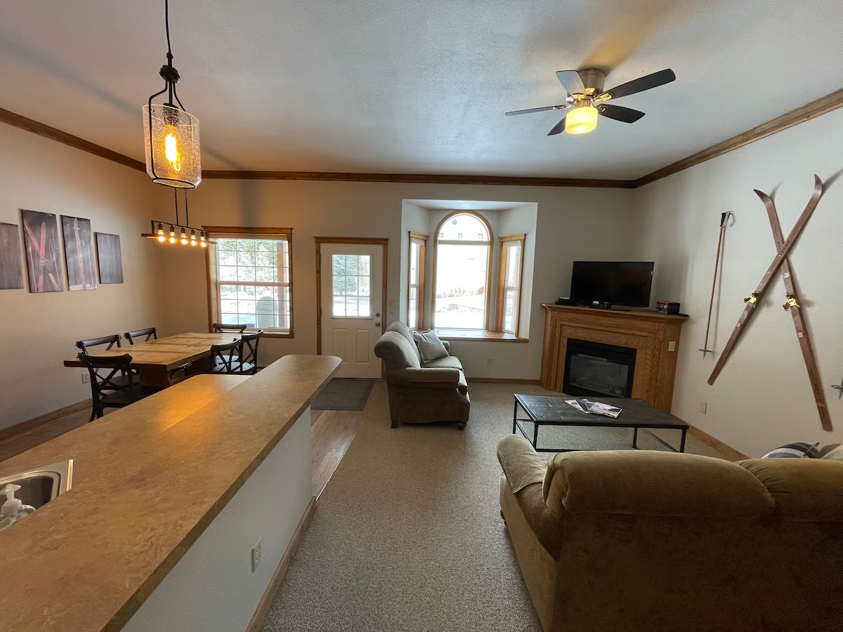 Open living and dining area with the breakfast bar, the fireplace and an arched window